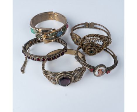 A collection of five antique gold tone bracelets from Czech Republic, Germany, and Austro-Hungary, each showcasing unique des