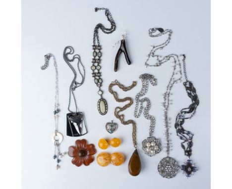 This auction lot features an array of vintage jewelry pieces. The first is a vintage Bakelite pendant necklace, showcasing th