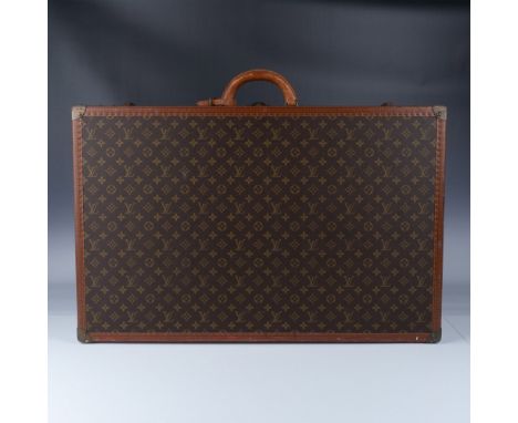 This vintage Louis Vuitton wardrobe trunk embodies timeless luxury and exceptional craftsmanship, showcasing the iconic monog