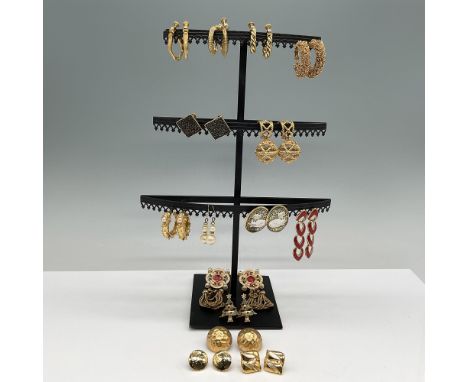 A curated collection of gold-tone costume earrings and accessories, featuring an assortment of styles including hoop, drop, s