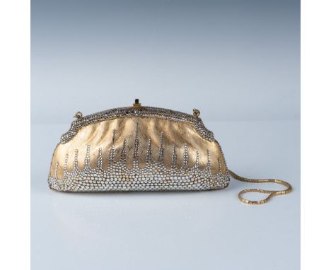 This vintage accessory set includes a dazzling Judith Leiber gold toned and rhinestone evening bag, a matching compact mirror