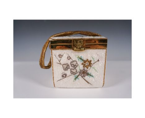 Vintage Kitty Bag evening handbag with intricate beaded floral design on a cream background, accented with gold-tone trim and