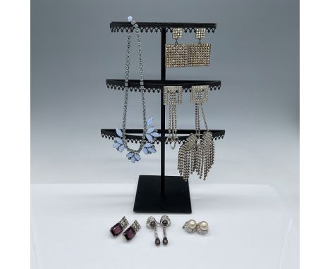 A collection of 7 pieces of vintage rhinestone jewelry, including 1 elegant necklace and 6 pairs of earrings. Two pairs of ea