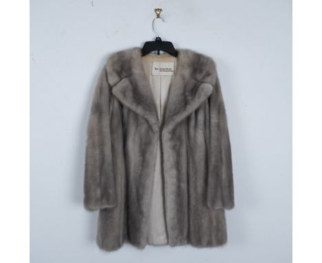 This elegant vintage mink fur coat, made by The Broadway, features a luxurious Silver Grey fur exterior, offering both warmth