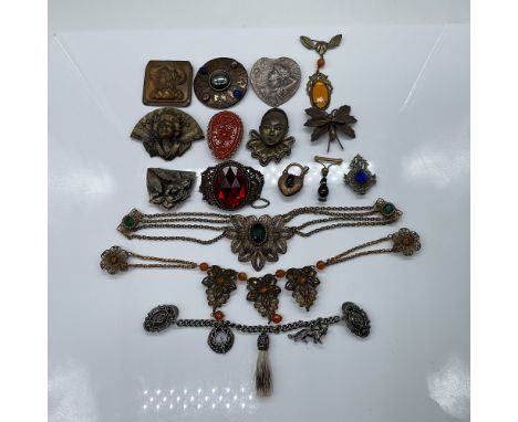 A collection of 16 antique and vintage ornate jewelry pieces, featuring a variety of designs including brooches, pins, sweate
