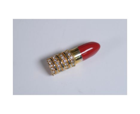 A glamorous rhinestone-encrusted lipstick brooch featuring a gold-tone metal base with a vibrant red enamel tip. The body is 