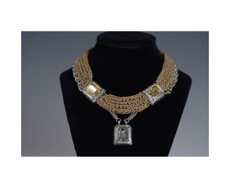 This elegant vintage necklace features an intricate chain-link design with faux gemstone accents in silver-tone settings. The