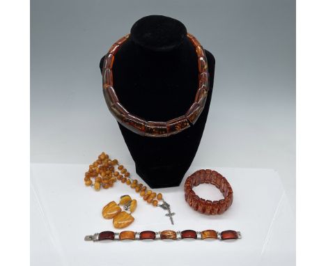 A collection of five amber jewelry pieces, including a Baltic amber chunky necklace (15"L), a Baltic amber stretch bracelet, 