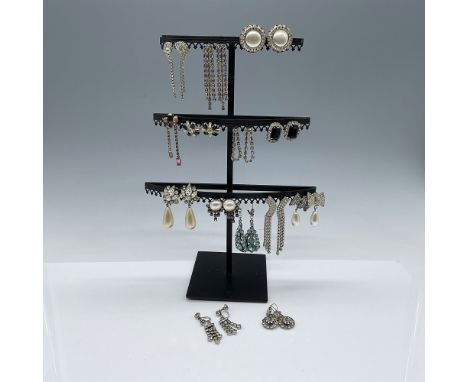 A collection of 14 pairs of antique rhinestone earrings, featuring various designs, including clip-ons and dangles. Highlight
