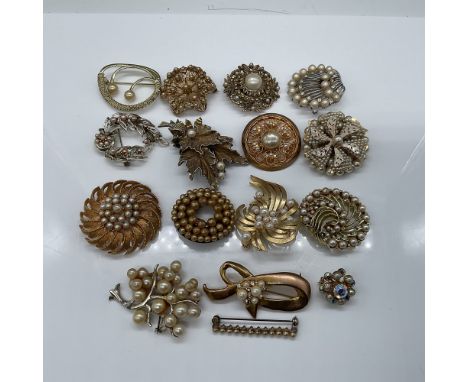 A collection of 16 vintage brooches featuring elegant faux pearl accents in a variety of designs, including floral, leaf, and