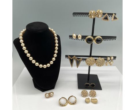 This lot features a curated selection of vintage-style costume jewelry, including a single-strand faux pearl necklace with a 