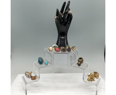 A collection of approximately 20 assorted vintage and modern costume rings, featuring a variety of designs and materials. The