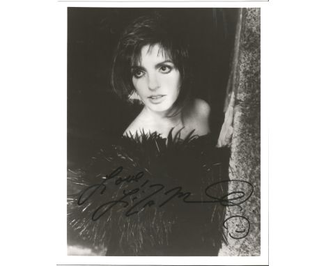 Liza Minelli signed 10 x 8 inch b/w early portrait photo, signed to slightly darker area. Good condition. All autographs come