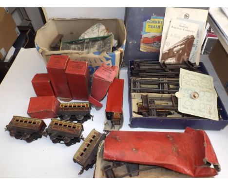 A collection of Hornby "0" gauge railway, including 0-4-0 locomotive, carriages and wagons plus "Hornby Railway Company" enam