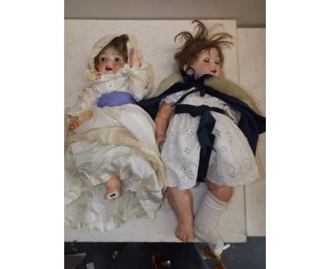 An "AM" porcelain head doll, head impressed "Germany 985 A 6 M" length 19", together with a Heubach porcelain head doll, head