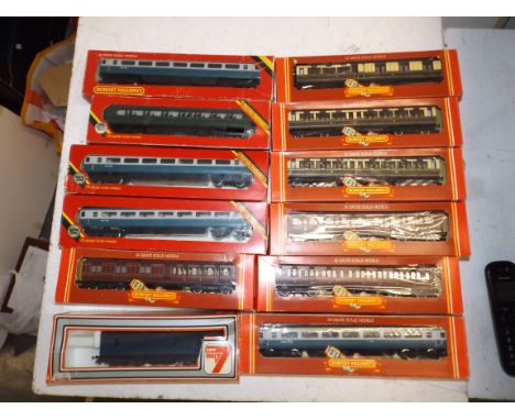 Eleven boxed carriages by Hornby and a boxed Lima wagon.