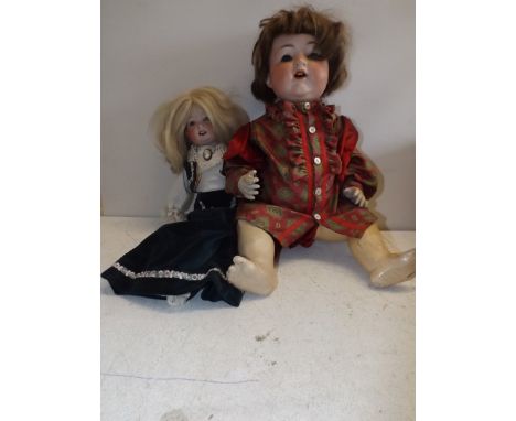 An "A.M." porcelain head doll, head impressed "Armand Marseille, Germany 992 A12 M" length 21" and one other, "Head impressed