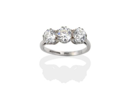 A Diamond Three Stone Ring, the old cut diamonds in white claw settings to a pointed shoulder plain polished shank, total est