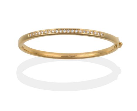 An 18 Carat Gold Diamond Bangle, half hinged and set with round brilliant cut diamonds to one half, total estimated diamond w