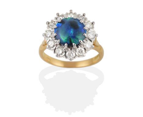 An 18 Carat Gold Black Opal and Diamond Cluster Ring, the polished round black opal within a border of twelve round brilliant