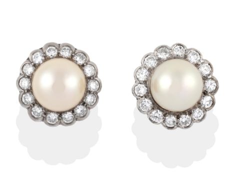 ^ A Pair of Cultured Pearl and Diamond Cluster Earrings, a cultured pearl within a border of round brilliant cut diamonds in 