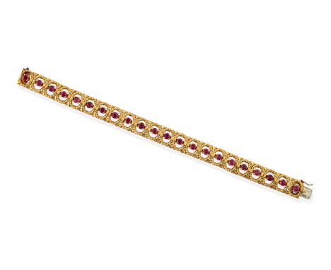 ^ An 18 Carat Gold Ruby Bracelet, round cut rubies in claw settings within oval rope frames, length 17.5cm see illustration .