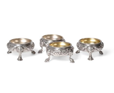 ^ A Set of Four George III Silver Salts, Robert Hennell, London 1817, circular with gadroon rim, the body with raised relief 