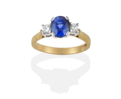 An 18 Carat Gold Sapphire and Diamond Three Stone Ring, the oval mixed cut sapphire between two round brilliant cut diamonds,