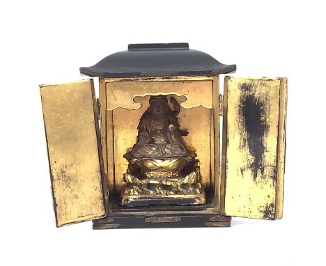 Japanese small Buddhist table shrine, early 20th Century. Gilt wood carved figure seated in a gilt and lacquered wood cabinet