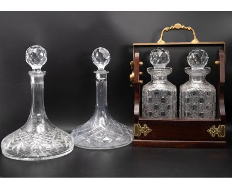 20th Century brass-bound mahogany tantalus, along with two ship's decanters. (3)