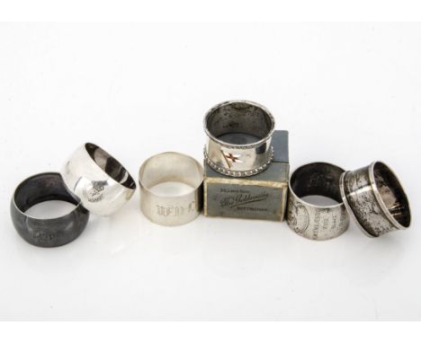 Four Edwardian and later silver napkin rings, one heavy example with engraved inscription for HMS Majestic, another with St G