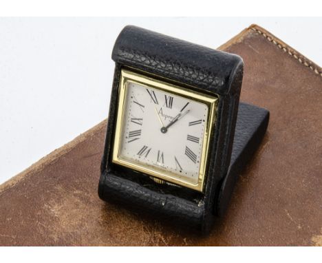 A c1980s travel clock from Asprey, AF and not functioning, the gilt square quartz time piece in black leather folding case
