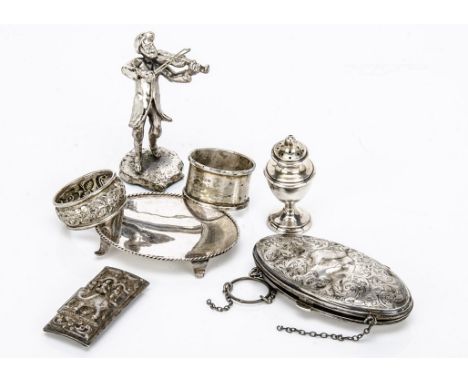 Seven items of silver and white metal, including an oval purse, dented, a small oval tray, two napkin rings, a figure playing