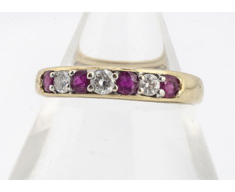 An 18ct gold diamond and ruby seven stone dress ring, the circular round cut rubies alternately set with brilliant cut diamon