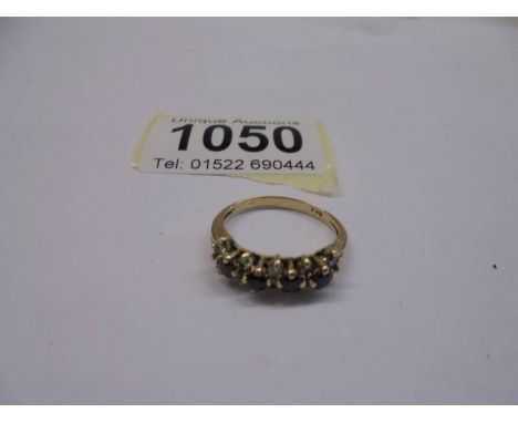 A 14k gold ring set rubies and diamonds, size M, 2.68 grams.