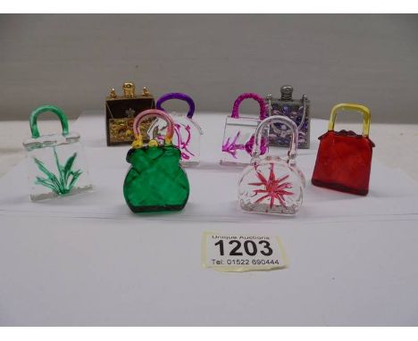 Two perfume bottles in the shape of handbags and six miniture glass handbag ornaments.