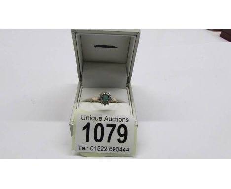 A diamond and emerald vintage cluster ring in a gold shank, size P, 1.87 grams.