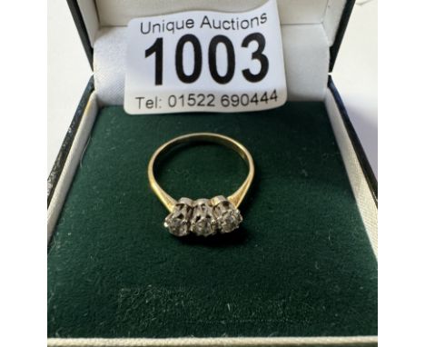 An 18ct 3 stone yellow gold diamond ring. 2.54 grams. Size N