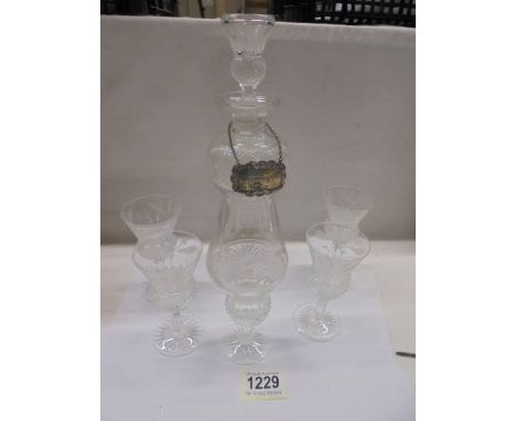 A cut glass thistle style decanter with 5 matching glasses and a sherry lable.