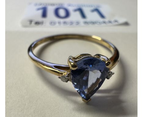 A yellow gold good colour tanzanite diamond ring. 1.37 grams. Size P
