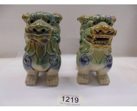 A pair of green ceramic Chinese Dogs of Fo.Height 14cm