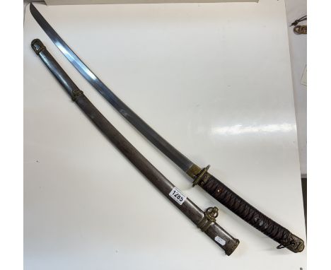 A Japanese swordBlade length 65cm from brass band to tip. Blade in clear polished condition. Scabbard has age related patina 