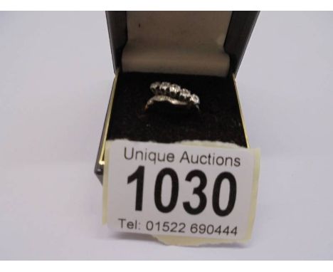An 18ct gold and platinum ring set five small diamonds, size O. 3.12 grams.