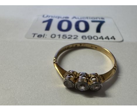 A yellow gold 3 stone diamond ring. 1.40 grams. Size K