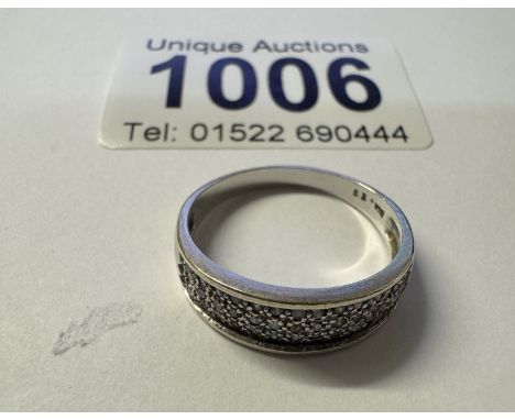 A 9ct white gold panel diamond ring. 2.80 grams. Size P