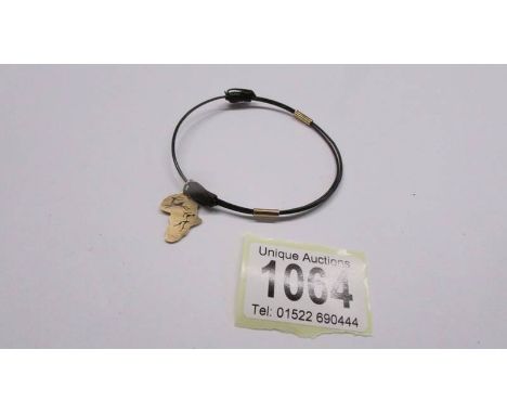 A vintage elephant hair bangle with 9ct gold mounts and charm.