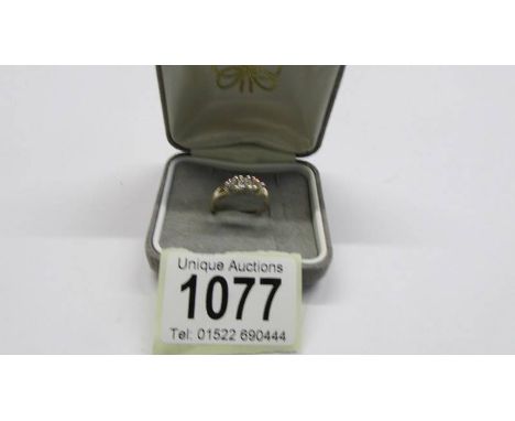 A diamond four stone ring in a gold setting and shank claw set, size N, 3.18 grams.