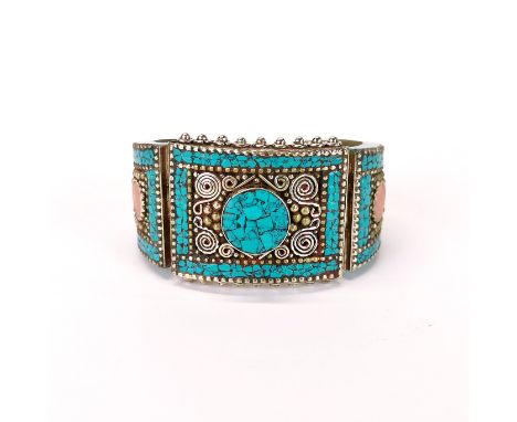 A Tibetan white metal hinged bangle, wrist width 6.5cm . Top panel 4.5cm.