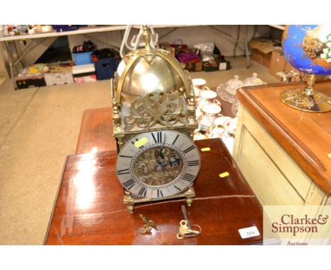 A brass lantern clock with fusee movement with pendulum and two keys 