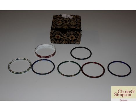 A trinket box set with multi coloured stones and contents and various enamels and cloisonné bangles 